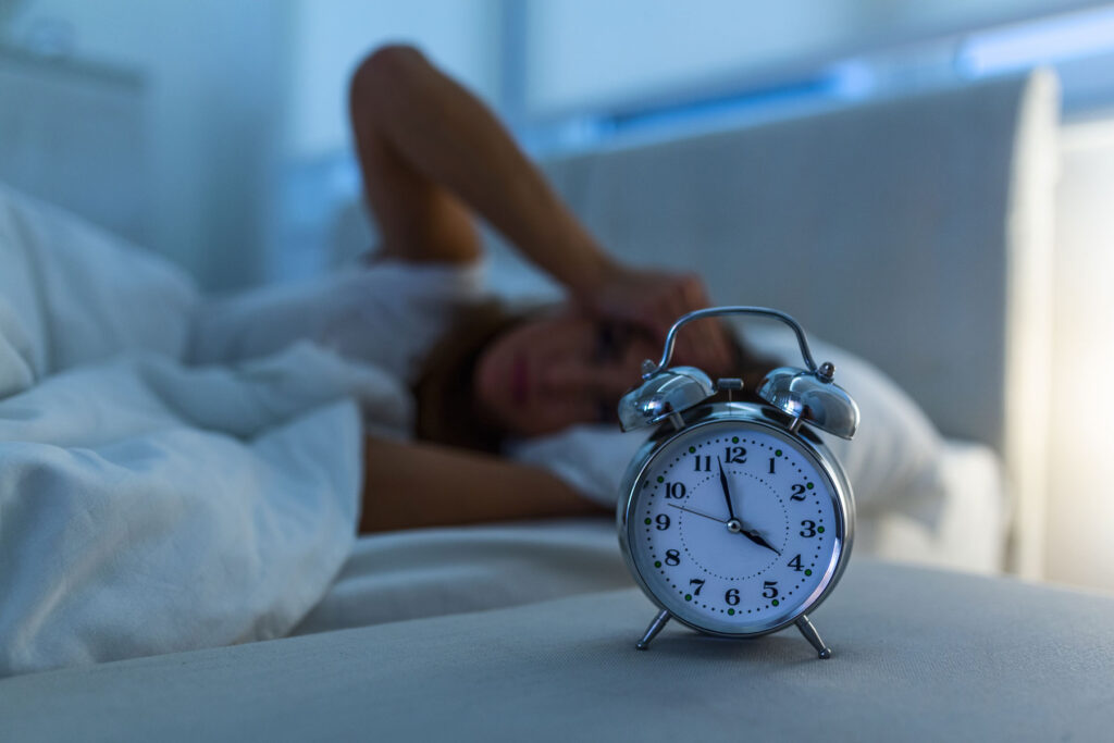 Person in bed wondering if lack of sleep can cause anxiety