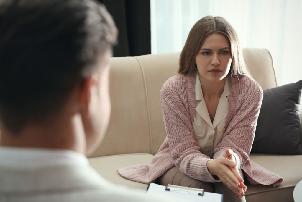 Woman talks to therapist about her trauma and substance abuse issues