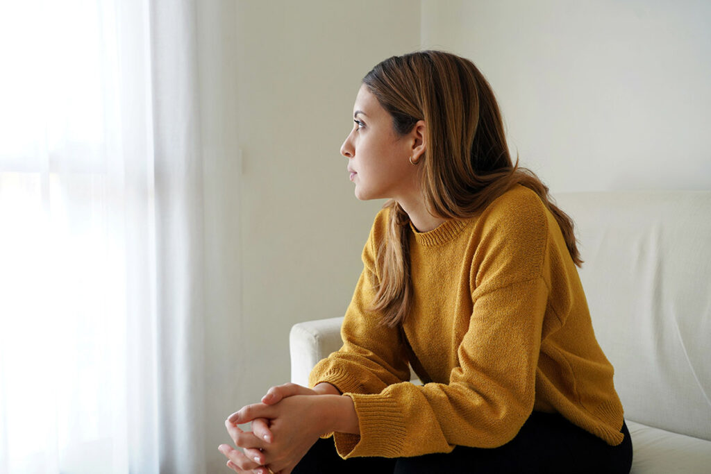 A woman wondering, "How does heroin affect the brain?"